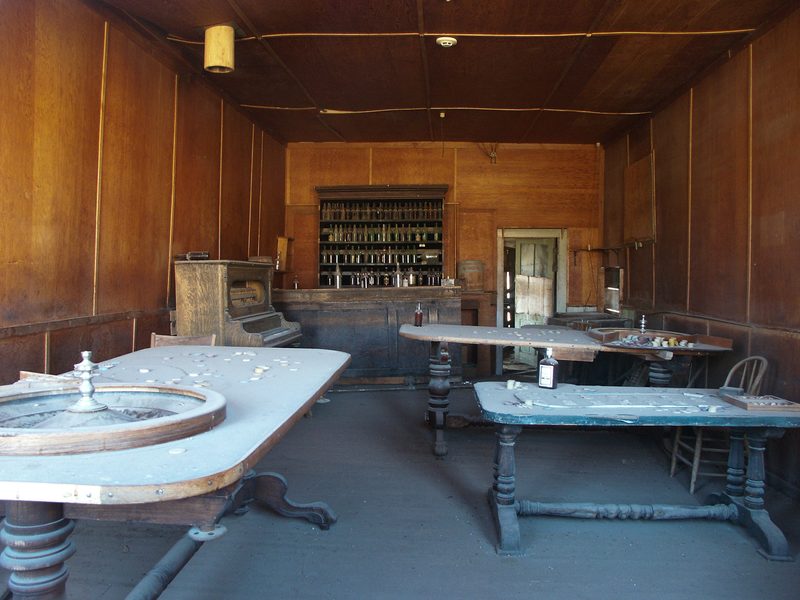 Saloon with roulette and faro tables.